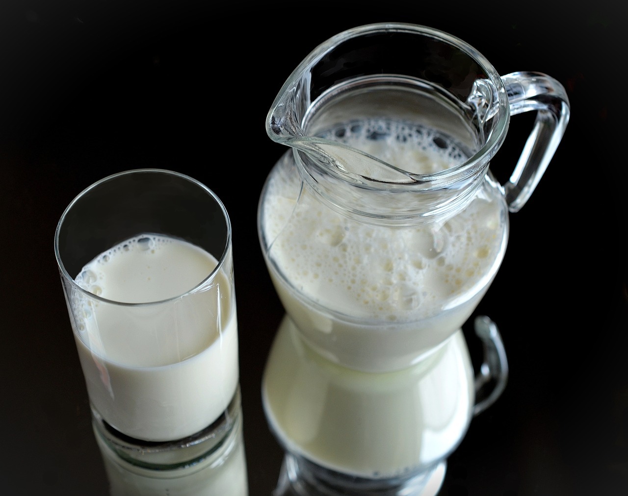 A glass of milk and a pitcher of milk
AI-generated content may be incorrect.