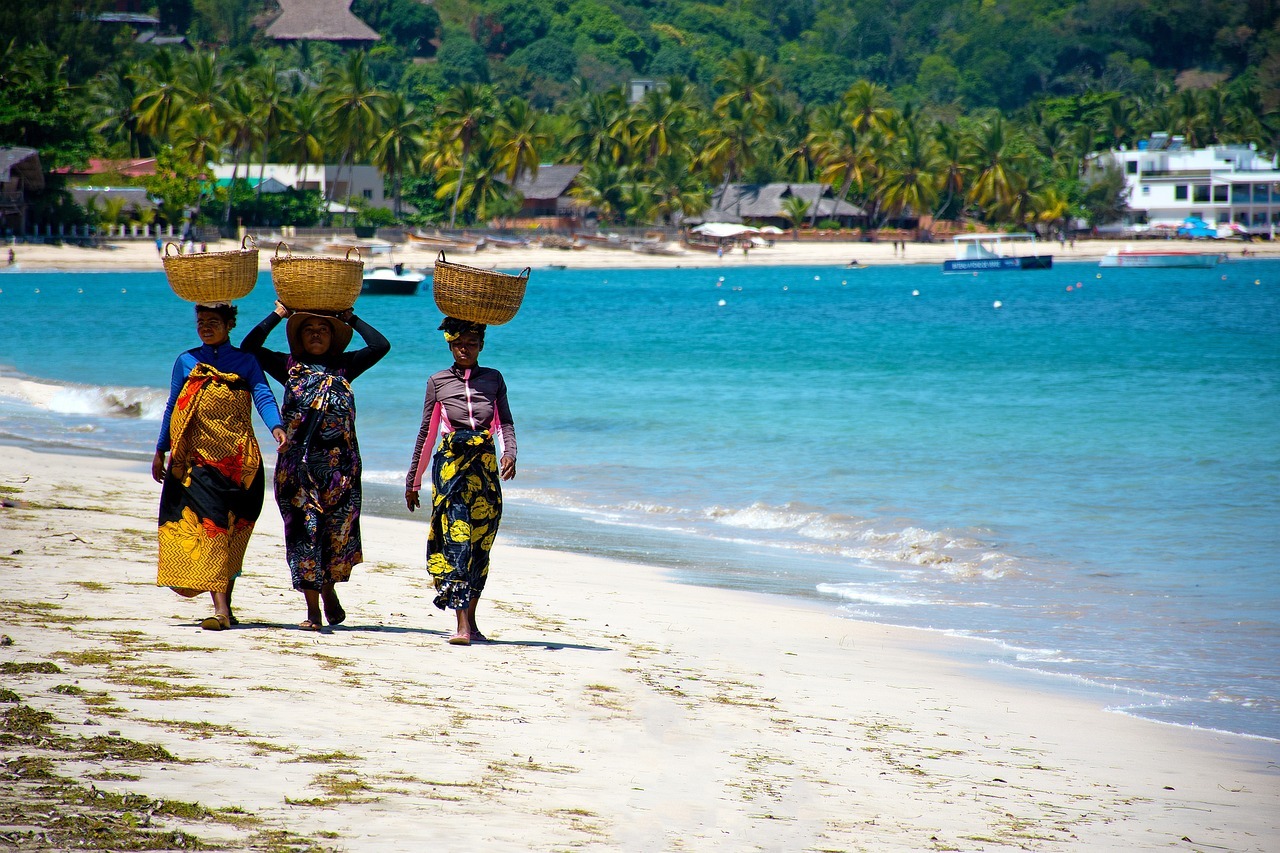 A group of women carrying baskets on their heads on a beach
AI-generated content may be incorrect.