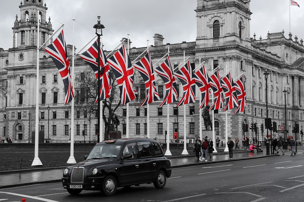A black car with red and white flags

AI-generated content may be incorrect.