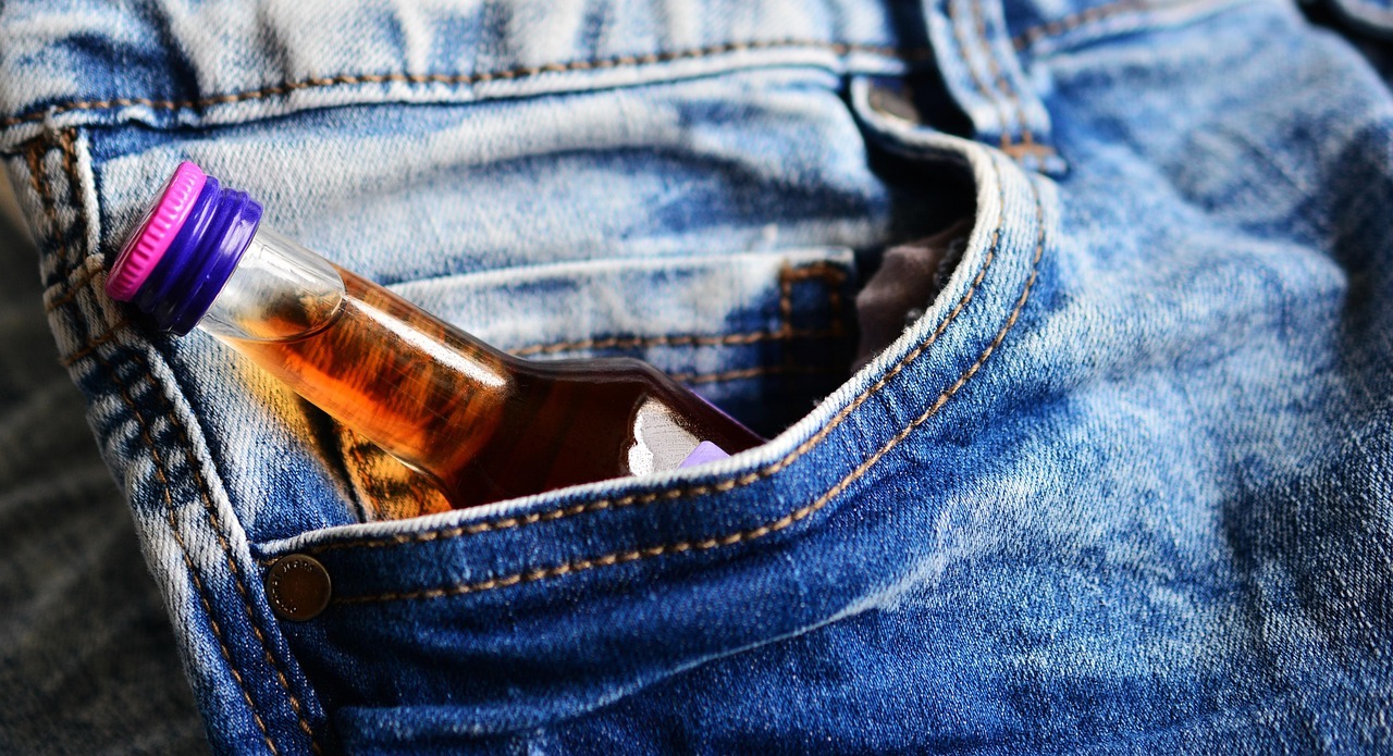 A bottle of alcohol in a pocket of jeans

AI-generated content may be incorrect.