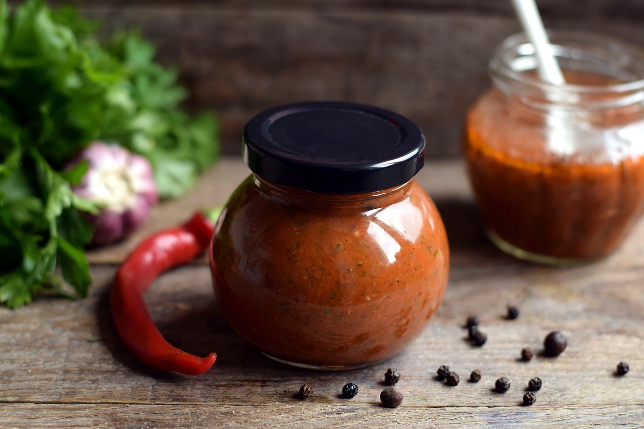 A jar of red sauce and a chili pepper

AI-generated content may be incorrect.