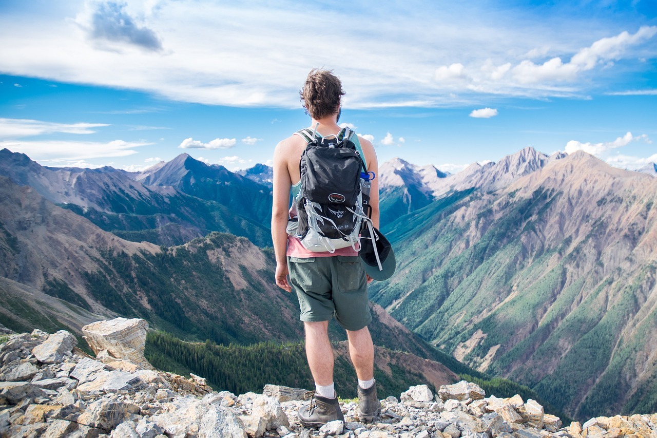 A person standing on a rocky mountain top looking at mountains

AI-generated content may be incorrect.